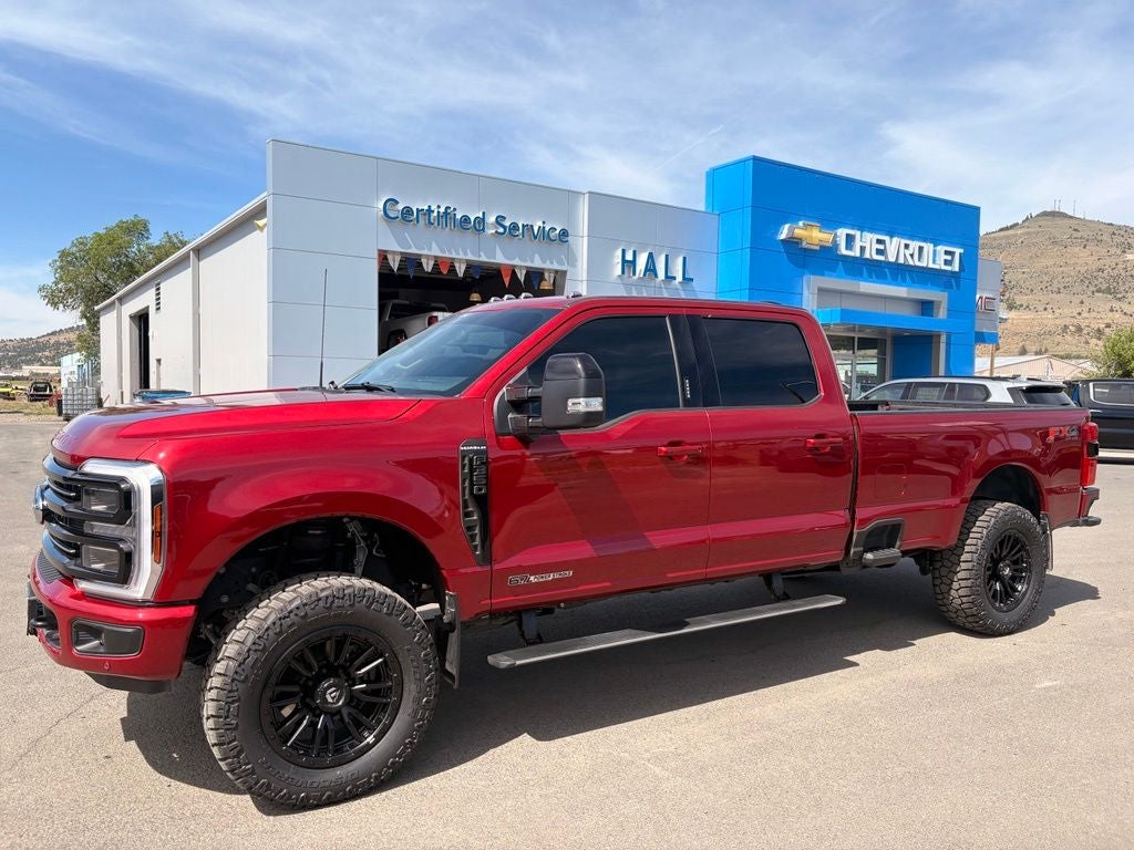 2026 Ford F-350SD Platinum in Ruby Red Metallic Tinted Clearcoat — front three-quarter view
